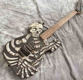 China Skull Carving Body 6 Strings Electric Guitar in Matte Black Color supplier